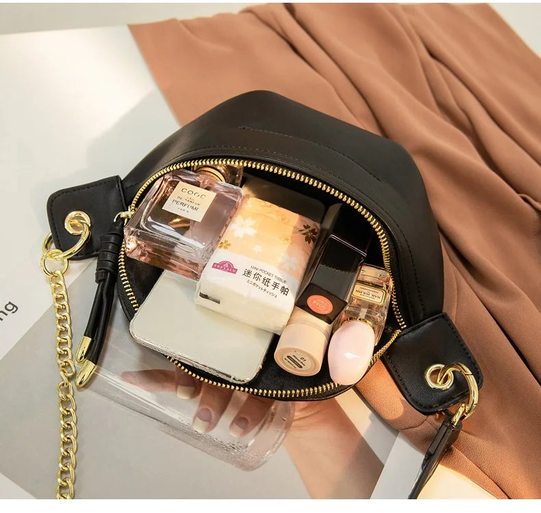 A black PU leather crossbody sling bag filled with perfume bottles and a white cosmetic item, resting on a beige fabric.