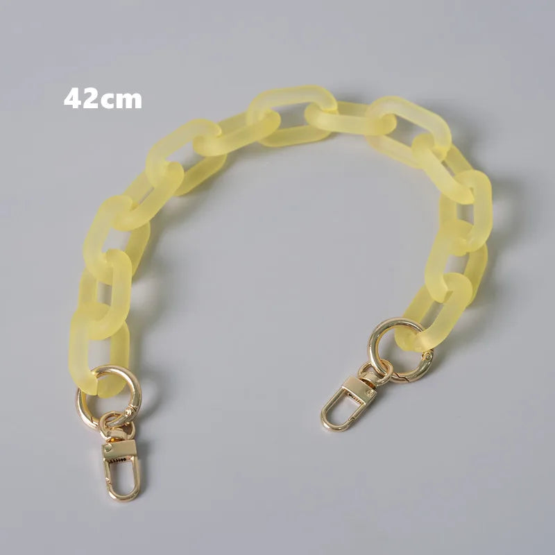 A yellow plastic chain shoulder bag measuring 42cm, shown laid out.