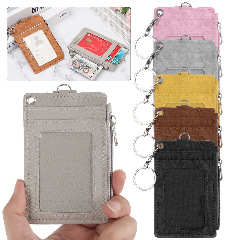 A collection of pink, gray, yellow, and brown PU leather card holder wallets with metal keychains.