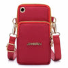 A deep red waterproof nylon crossbody bag with gold accents and a flap closure.
