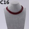 A close-up of a dark red acrylic link chain necklace displayed on a mannequin neck.