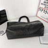 A black oversized PU leather tote bag with a handle is displayed on a white surface.