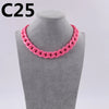 A pink acrylic link chain necklace displayed on a gray mannequin neck.