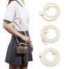 A woman models a white shirt and gray skirt while displaying pearl straps for a handbag and purse.