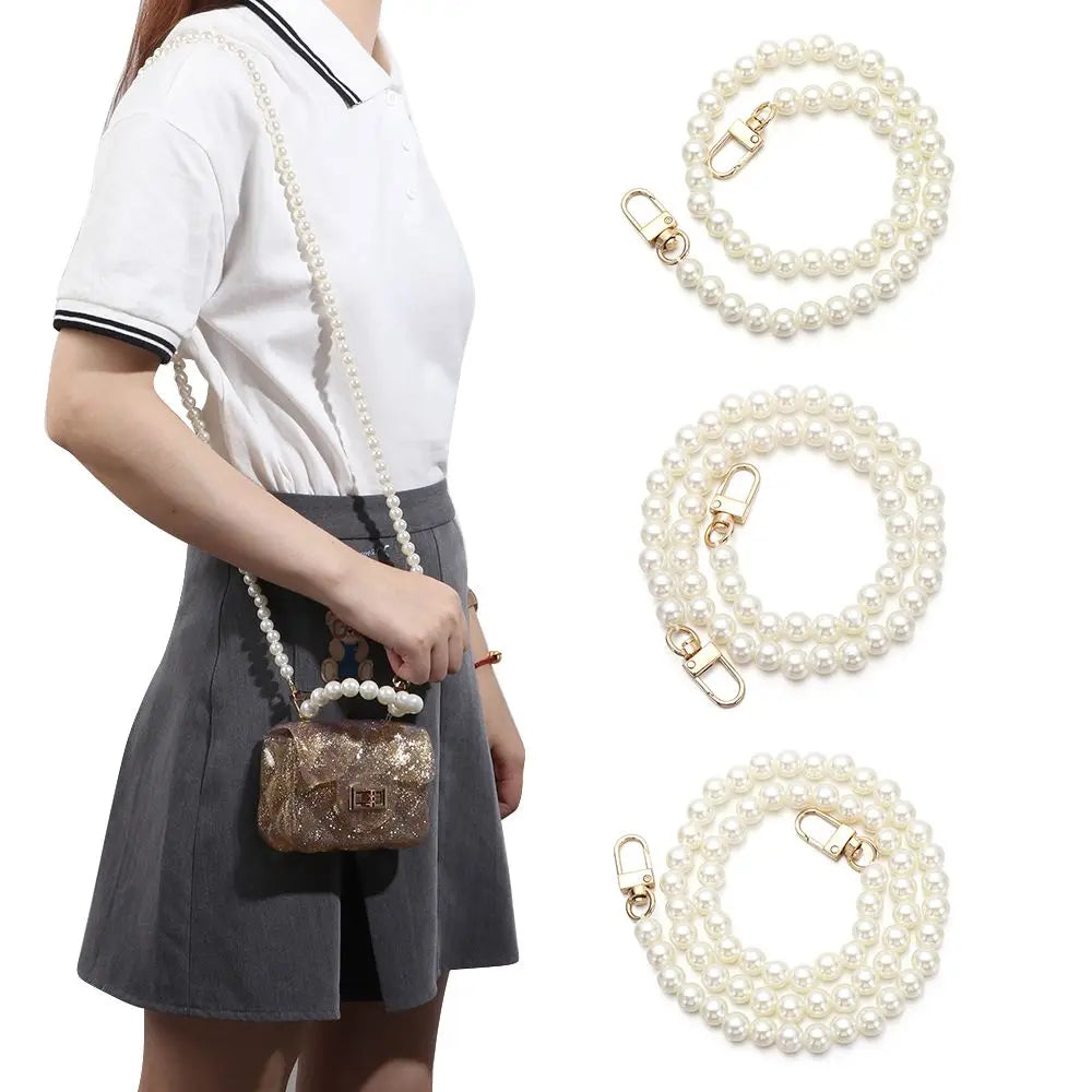 A woman models a white shirt and gray skirt while displaying pearl straps for a handbag and purse.