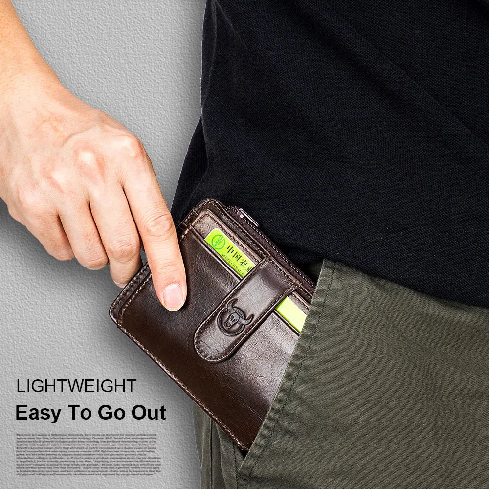 A hand holds a brown genuine leather RFID blocking card holder against a dark shirt and olive green pants.