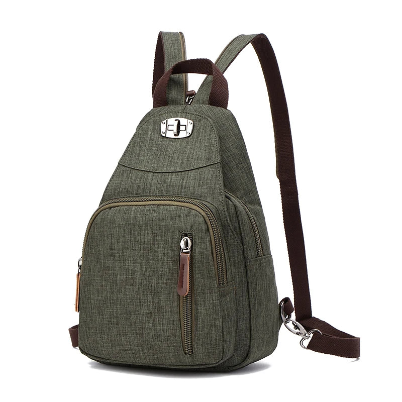 A dark olive green canvas backpack with brown straps and zippered pockets.