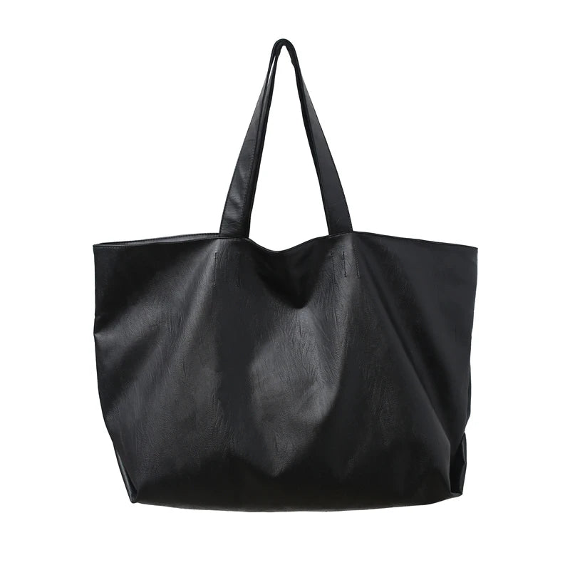 A black oversized PU leather tote bag with a handle is shown against a white background.
