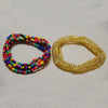 Two bracelets made of colorful belly bead chains, one multi-colored and one gold.