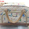 A small size beige and patterned PU leather travel duffel bag with brown trim.