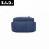 A dark blue canvas backpack with a top zipper visible.