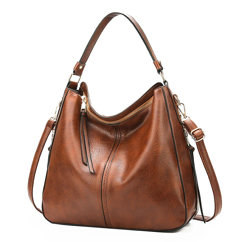A brown vintage faux leather hobo shoulder bag with a gold-toned strap and zipper detail.
