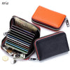 An orange leather accordion card holder wallet is shown next to a black leather wallet filled with credit cards and coins.