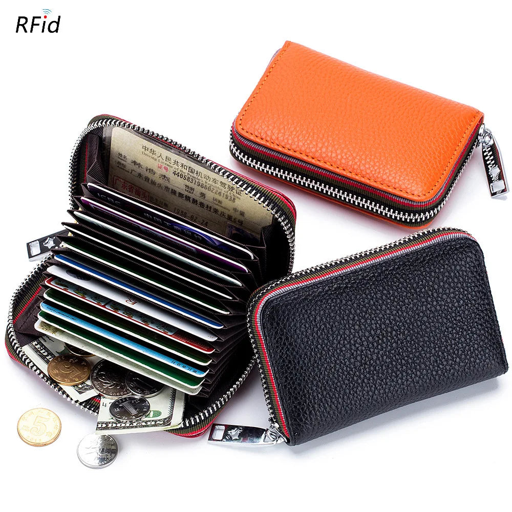 An orange leather accordion card holder wallet is shown next to a black leather wallet filled with credit cards and coins.