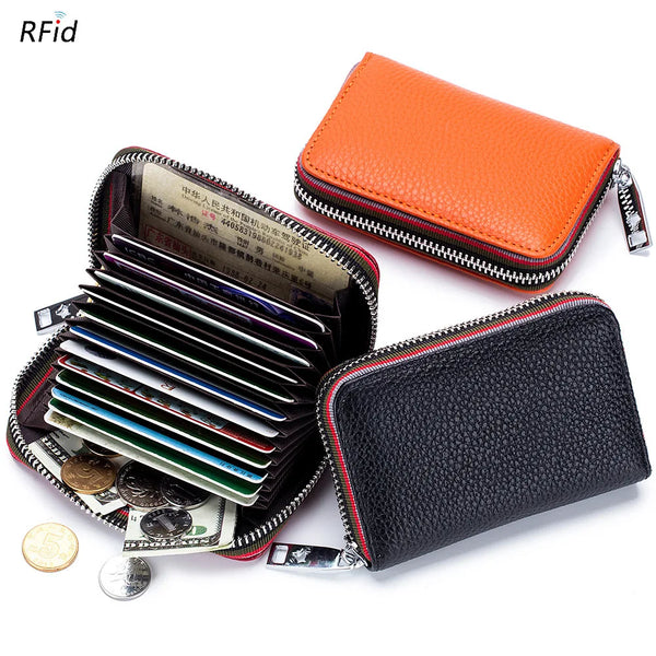 An orange leather accordion card holder wallet is shown next to a black leather wallet filled with credit cards and coins.