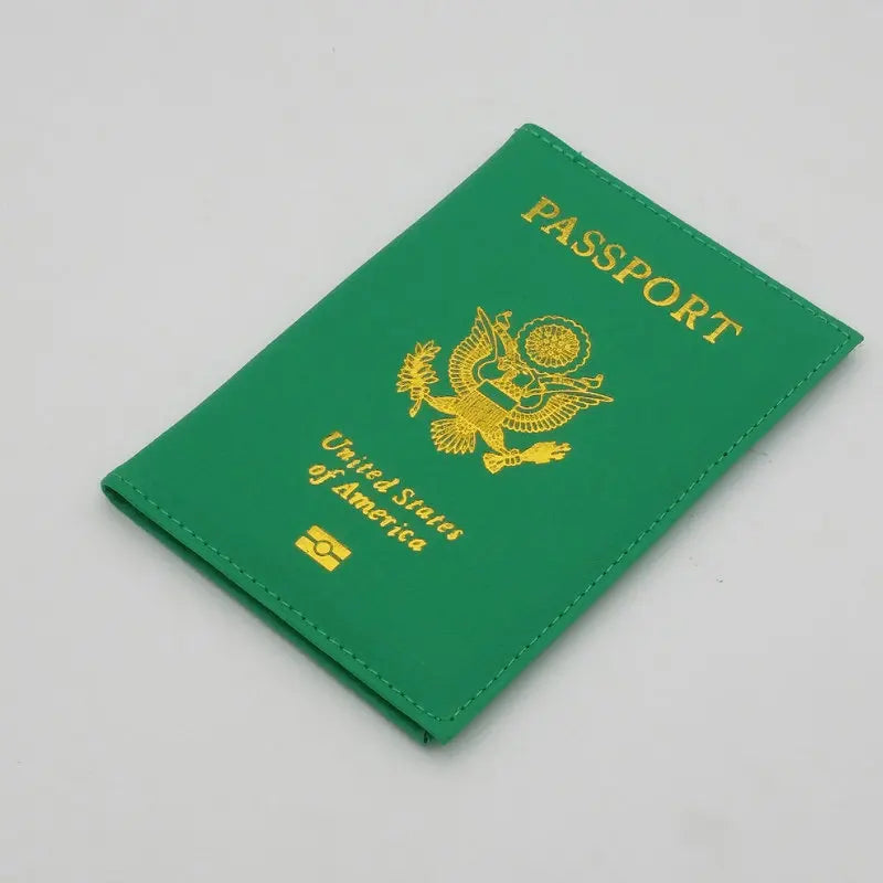 A green leather passport holder with gold lettering and an eagle design.