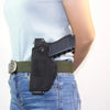 A black universal IWB concealment holster with a metal belt clip worn on a person's waist.