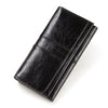 A black genuine leather clutch wallet folded and displayed diagonally.