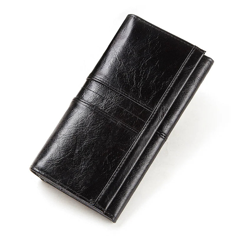 A black genuine leather clutch wallet folded and displayed diagonally.