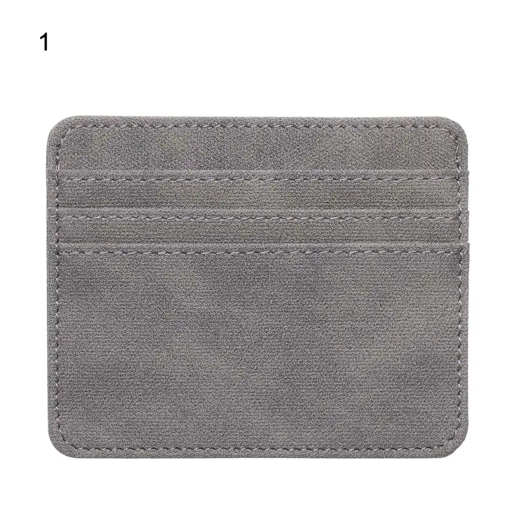 A gray PU leather card holder wallet with a stitched design.