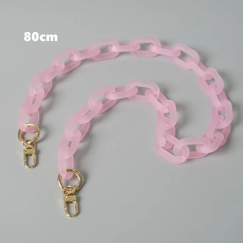 A pink adjustable detachable chain shoulder bag with gold-colored clasps.