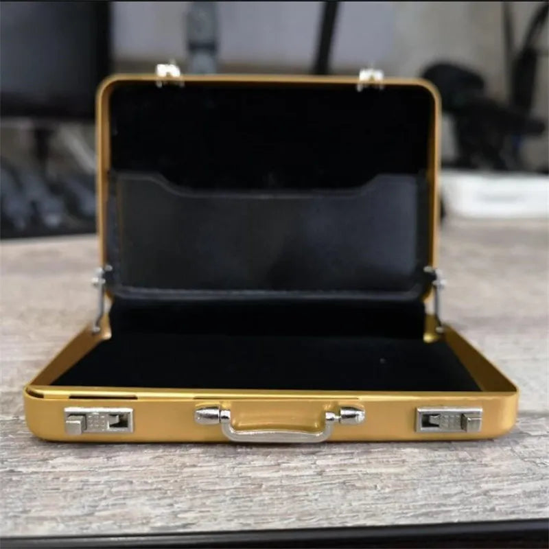 A gold-colored aluminum case for holding credit cards and IDs, shown open on a wooden surface.