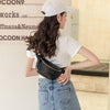 A woman wearing a white cap and white shirt holds a black PU leather crossbody sling bag.