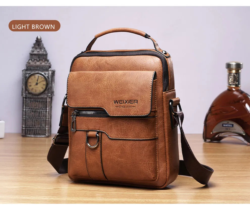 A light brown vintage PU leather crossbody messenger bag resting on a wooden surface.