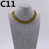 A gold-colored acrylic link chain necklace displayed on a mannequin neck.