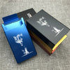 A blue custom engraved cigarette case is shown next to a black and gold box, featuring a wolf design.