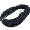 A coil of black braided leather cord used for jewelry making.
