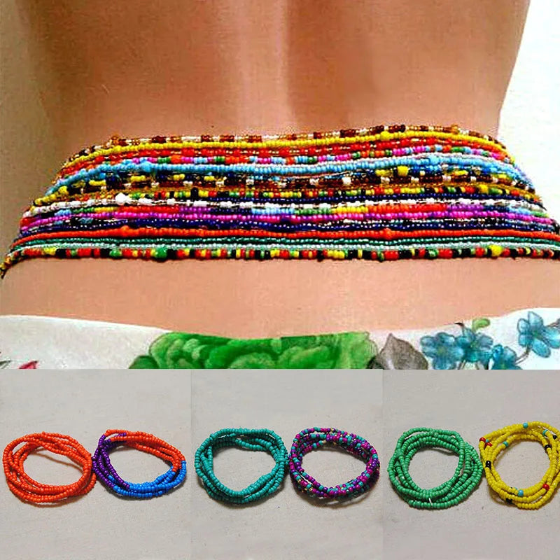 Colorful belly bead chains for body jewelry displayed on a person's abdomen.