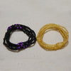 Two strands of colorful belly bead chains, one black and purple, and one yellow.
