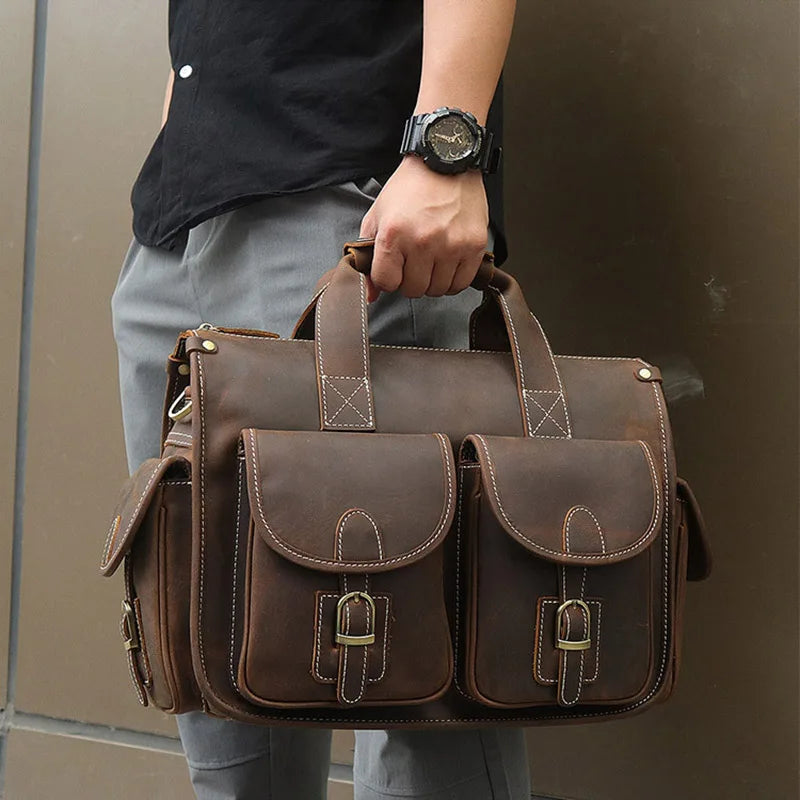 A brown genuine cowhide leather briefcase carried by a person, shown from the front.
