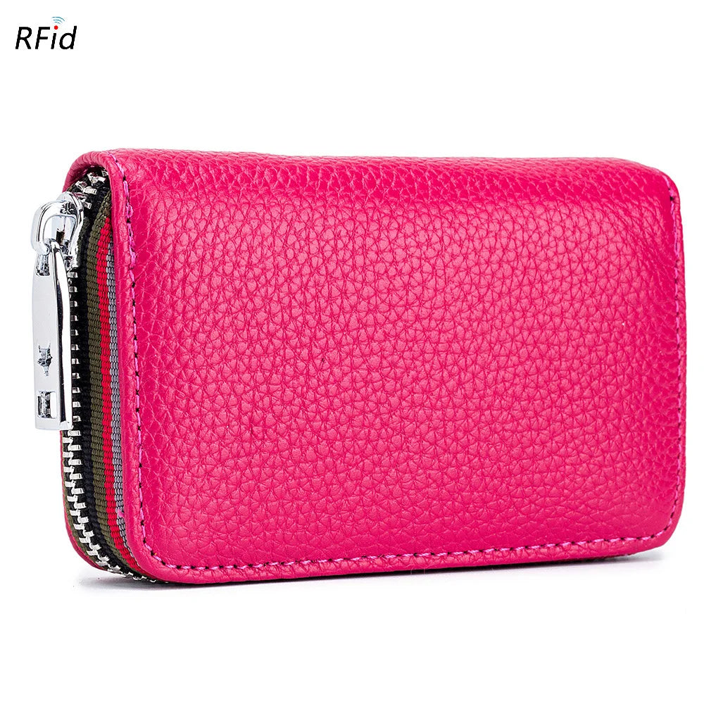 A vibrant pink genuine leather accordion card holder wallet with a zippered closure.