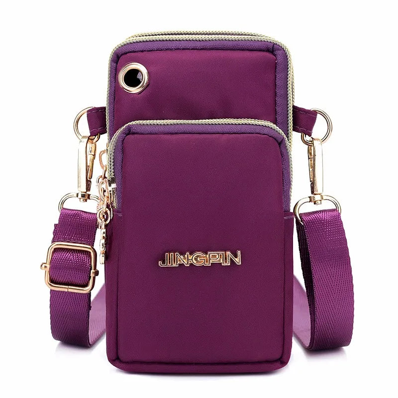 A purple waterproof nylon crossbody bag with gold hardware and a matching strap.