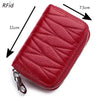 A red genuine leather RFID women's travel wallet with a zipper closure shown from above.