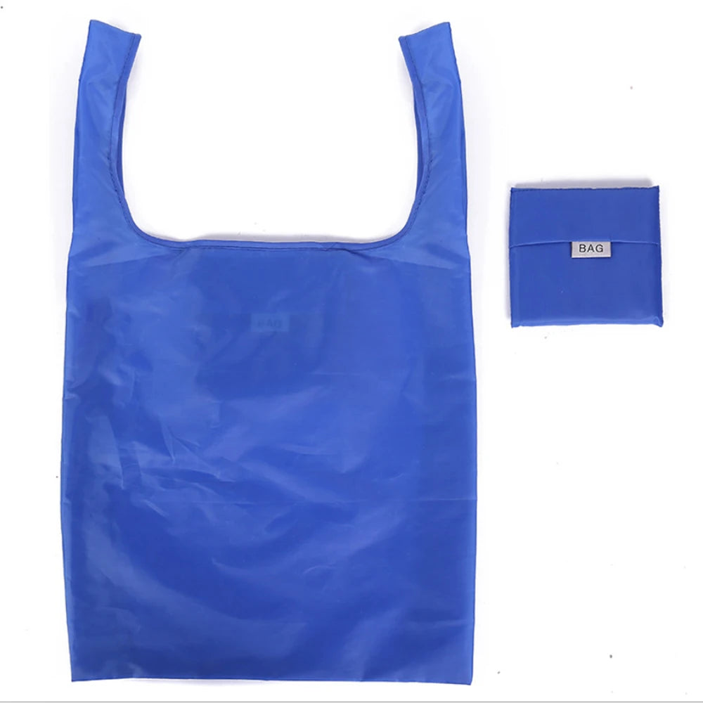 A bright blue, flexible plastic shopping bag with a small tag is shown.