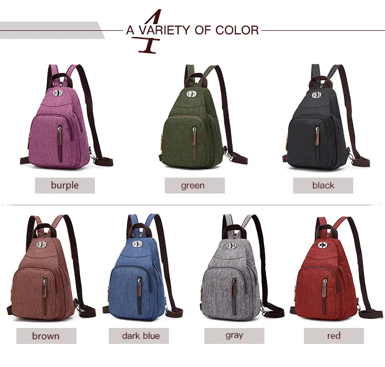A variety of colored canvas backpacks including purple, green, black, brown, dark blue, gray, and red.