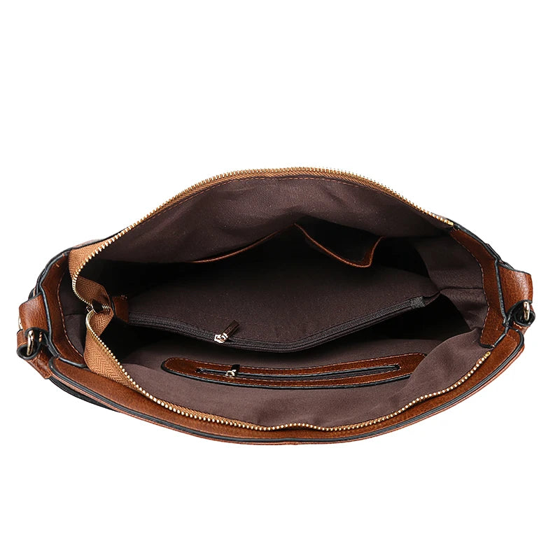 A brown vintage faux leather hobo shoulder bag shown open, displaying its interior lining and zipper details.