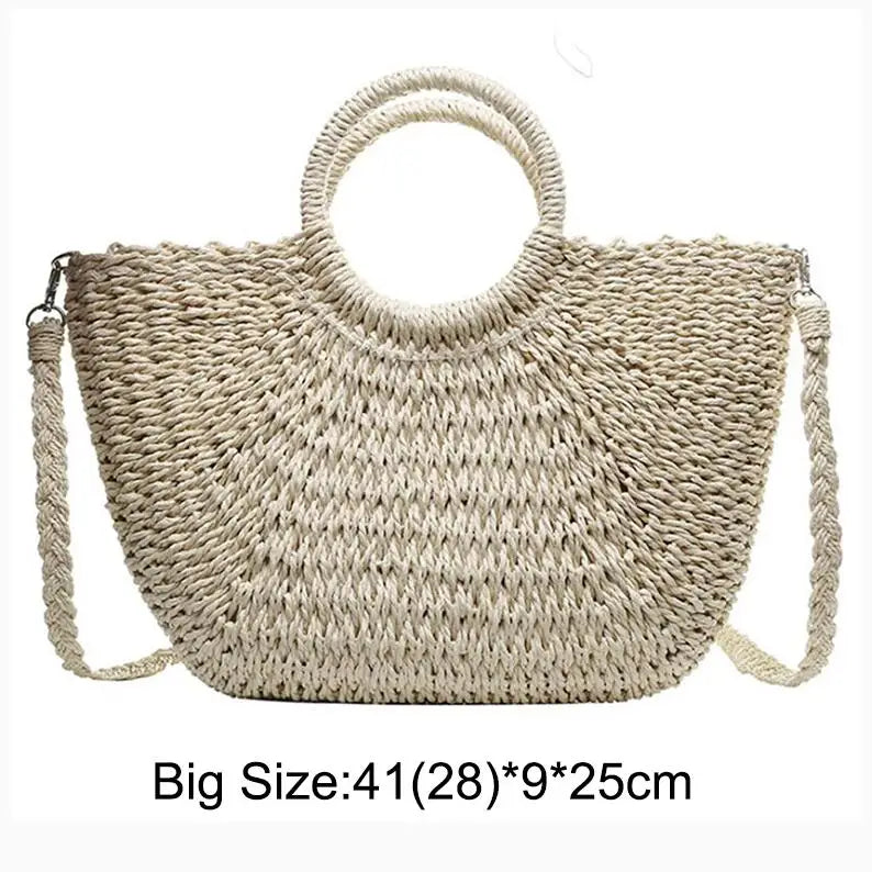 Handwoven straw moon bag with a top handle in a natural beige color.
