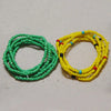 Two circular strands of colorful belly bead chains, one green and one yellow.
