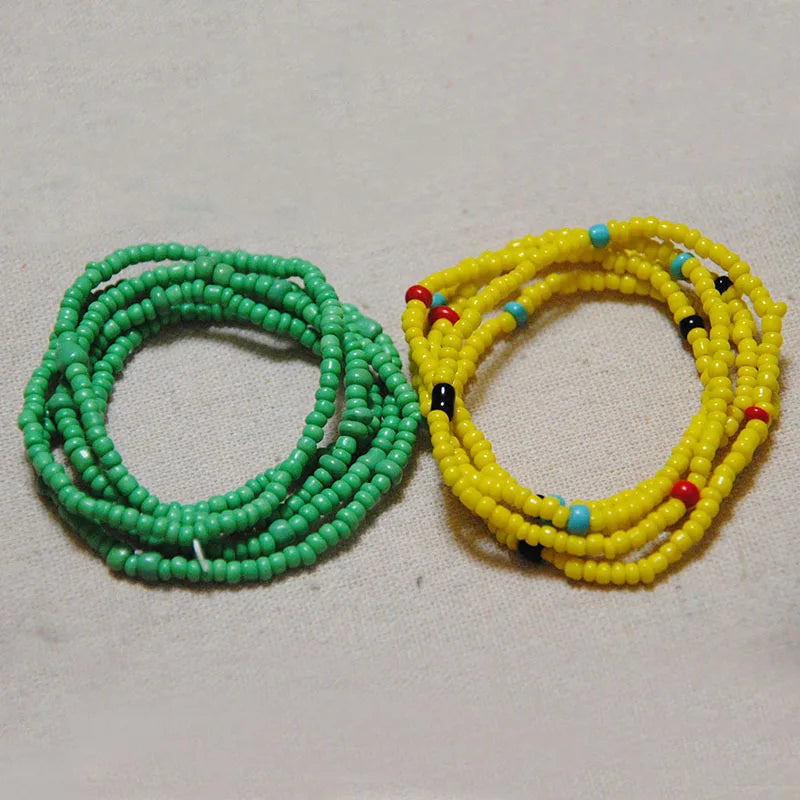 Two circular strands of colorful belly bead chains, one green and one yellow.
