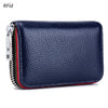 A dark blue genuine leather accordion card holder wallet with a zipper and metallic clasp.