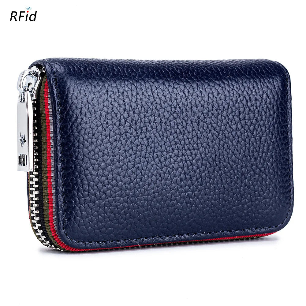 A dark blue genuine leather accordion card holder wallet with a zipper and metallic clasp.