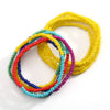 A collection of colorful belly bead chains featuring yellow, pink, blue, and green beads.