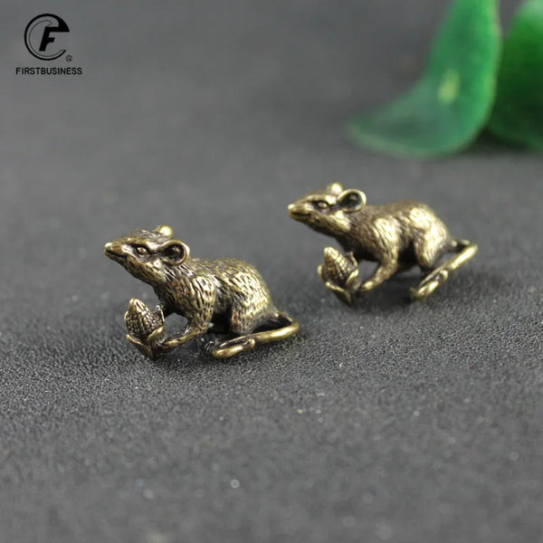 A vintage brass figurine of a rat for good luck and home decor