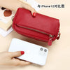 A red genuine cowhide leather double-zip wristlet wallet is shown next to an iPhone 12 for comparison.