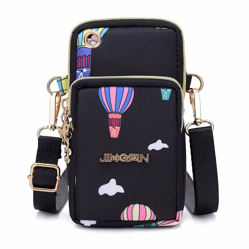 Black waterproof nylon crossbody bag featuring colorful striped accents and gold hardware.