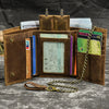 A brown leather trifold wallet with a detachable gold chain, holding cash and cards.